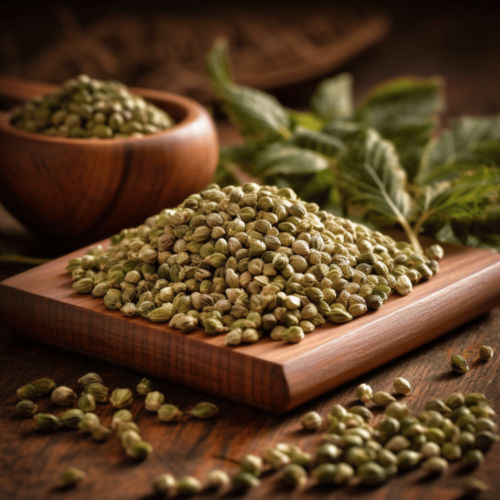 A pile of nutritious hemp seeds on a wooden surface, with a few seeds scattered around