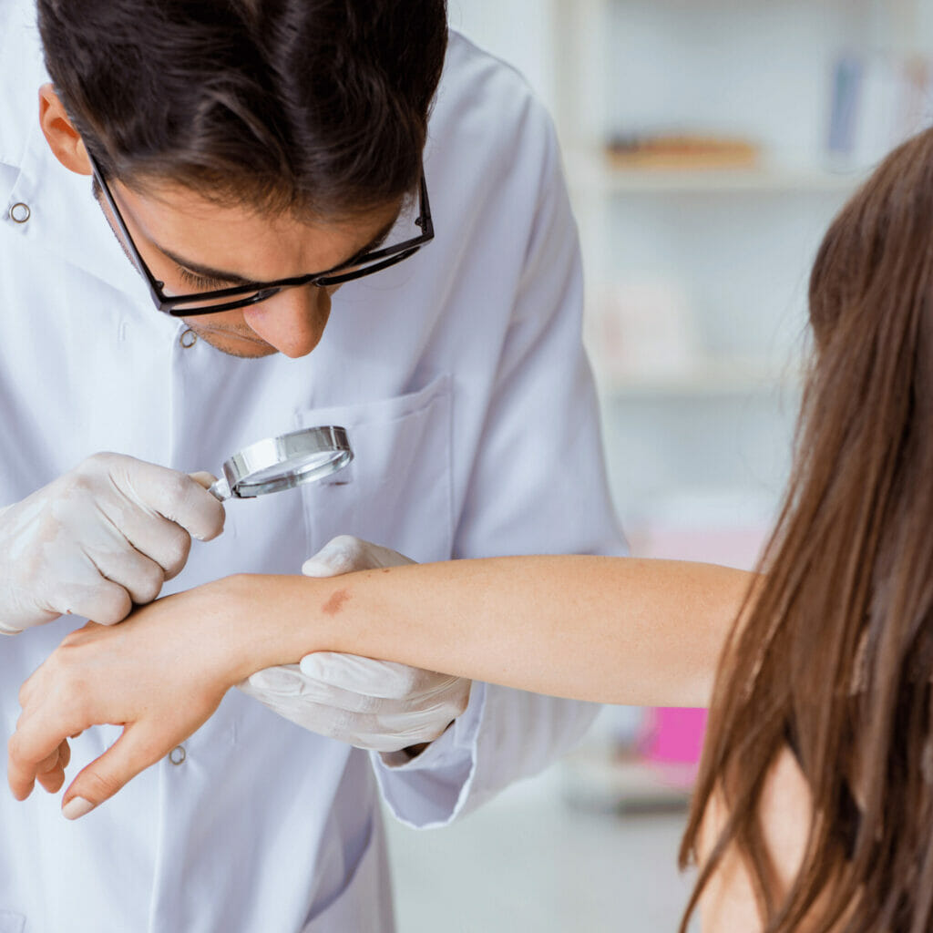 doctor examining patient's skin