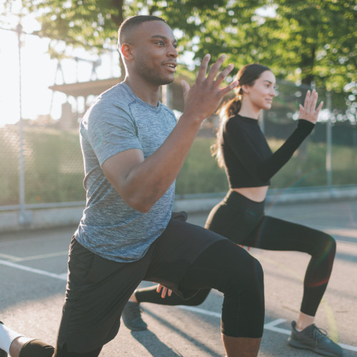 athletic couple exercising outdoors