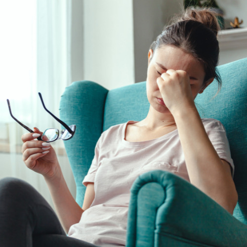 young woman with eyeglasses suffers eye fatigue