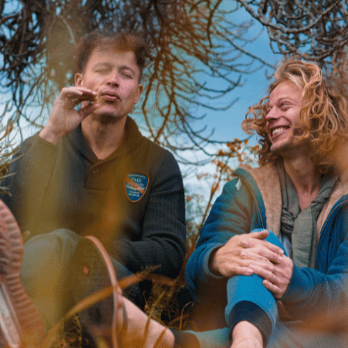 friends sitting on the ground while smoking weed
