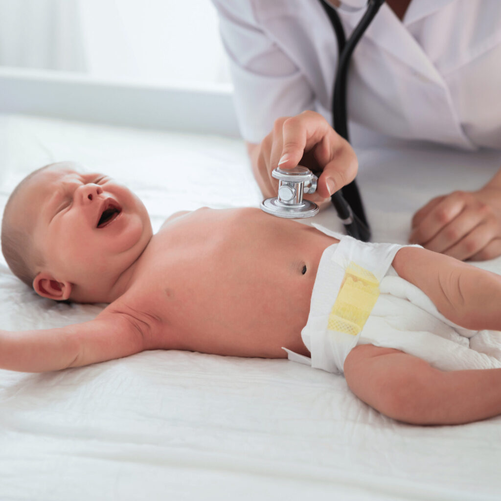 pediatrician checking up baby