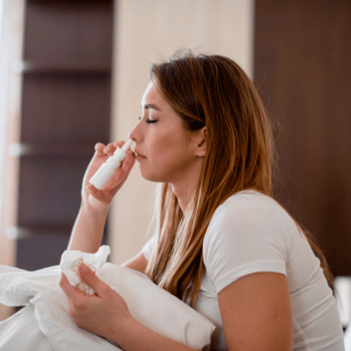 Woman using nasal spray